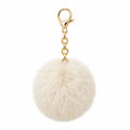 LES CHARMS — pompon fourrure synthétique crème, mousqueton métal ton or